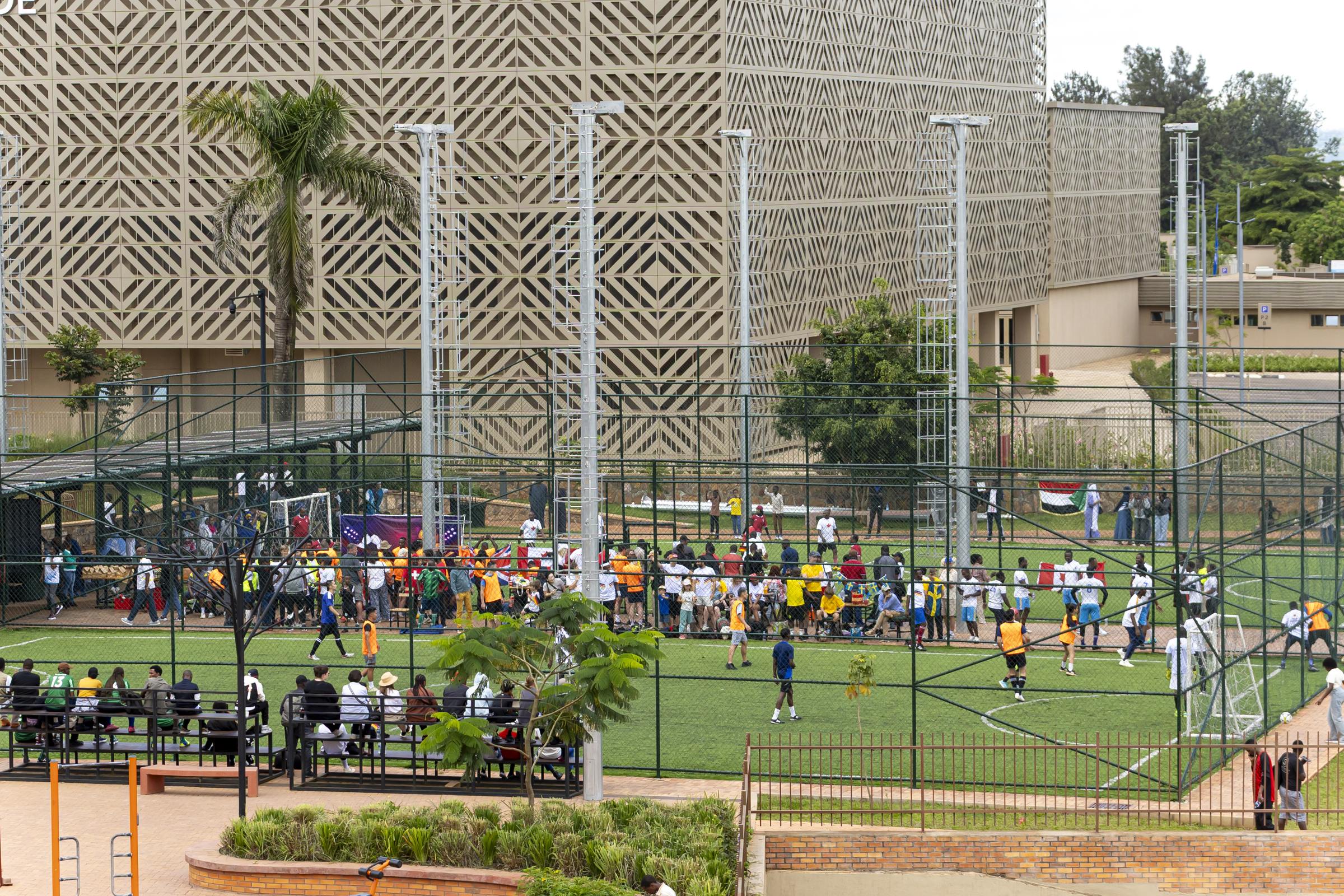 Five-a-side pitch in use at Zaria Court Kigali with Amahoro Stadium behind