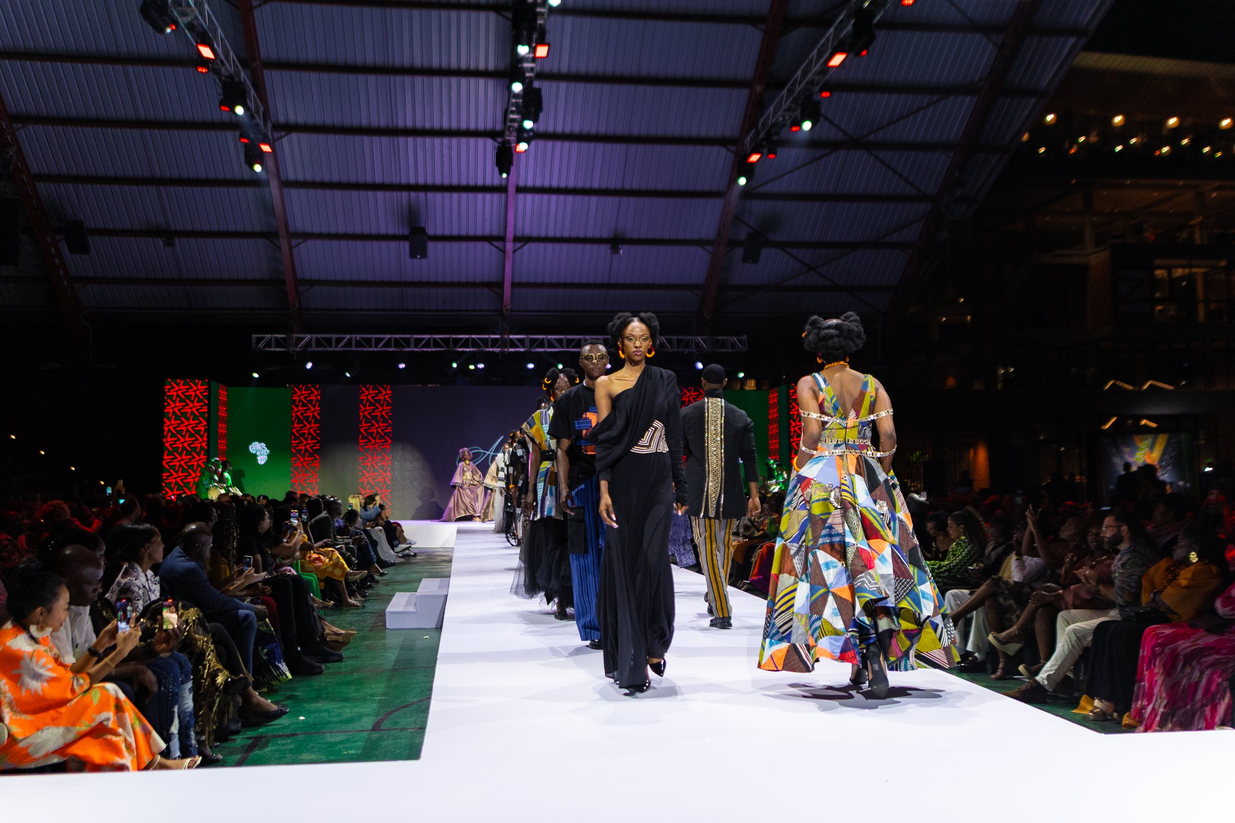Models walking a runway show staged on the court at Zaria Court Kigali