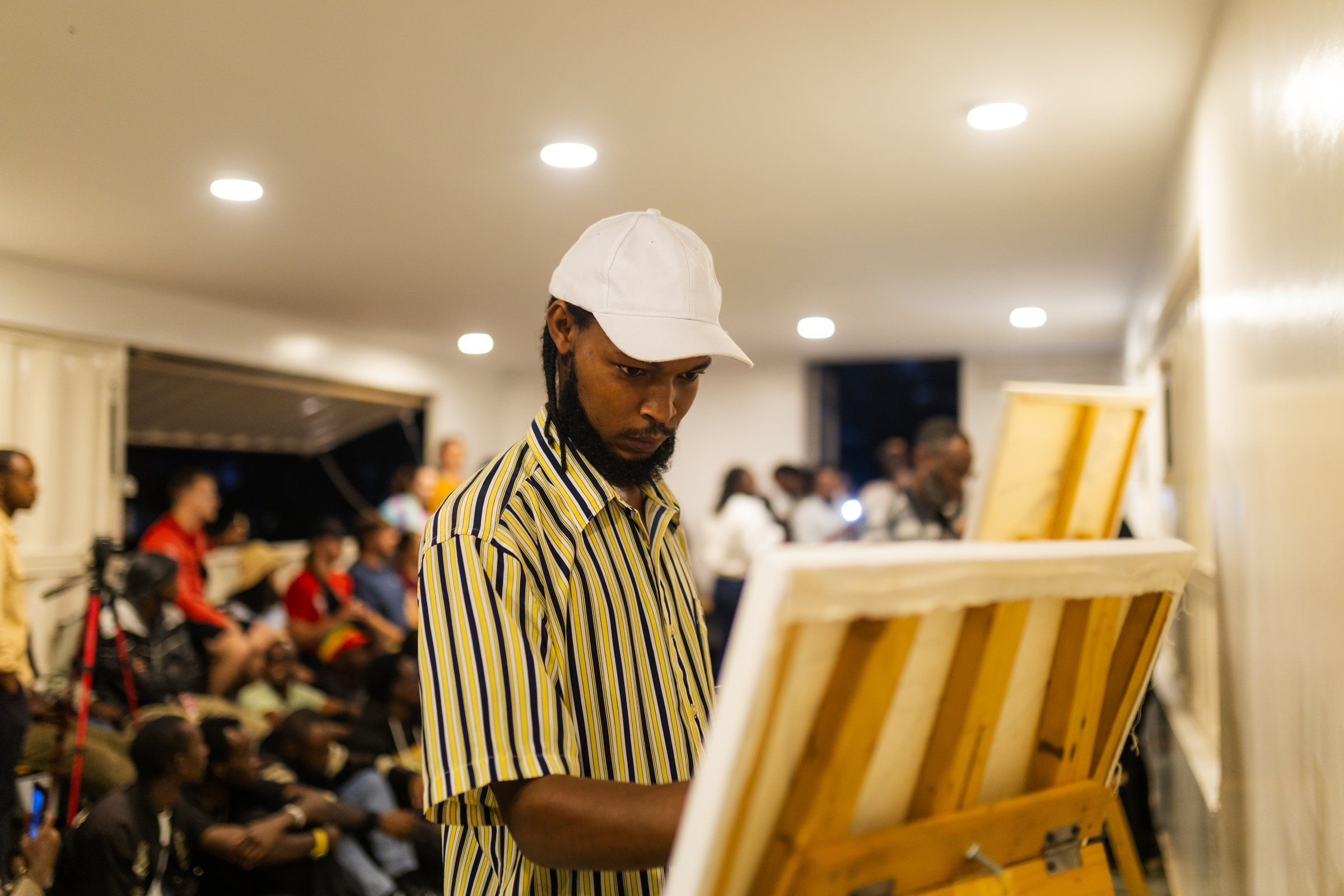Artist live painting during an event at Zaria Court Kigali