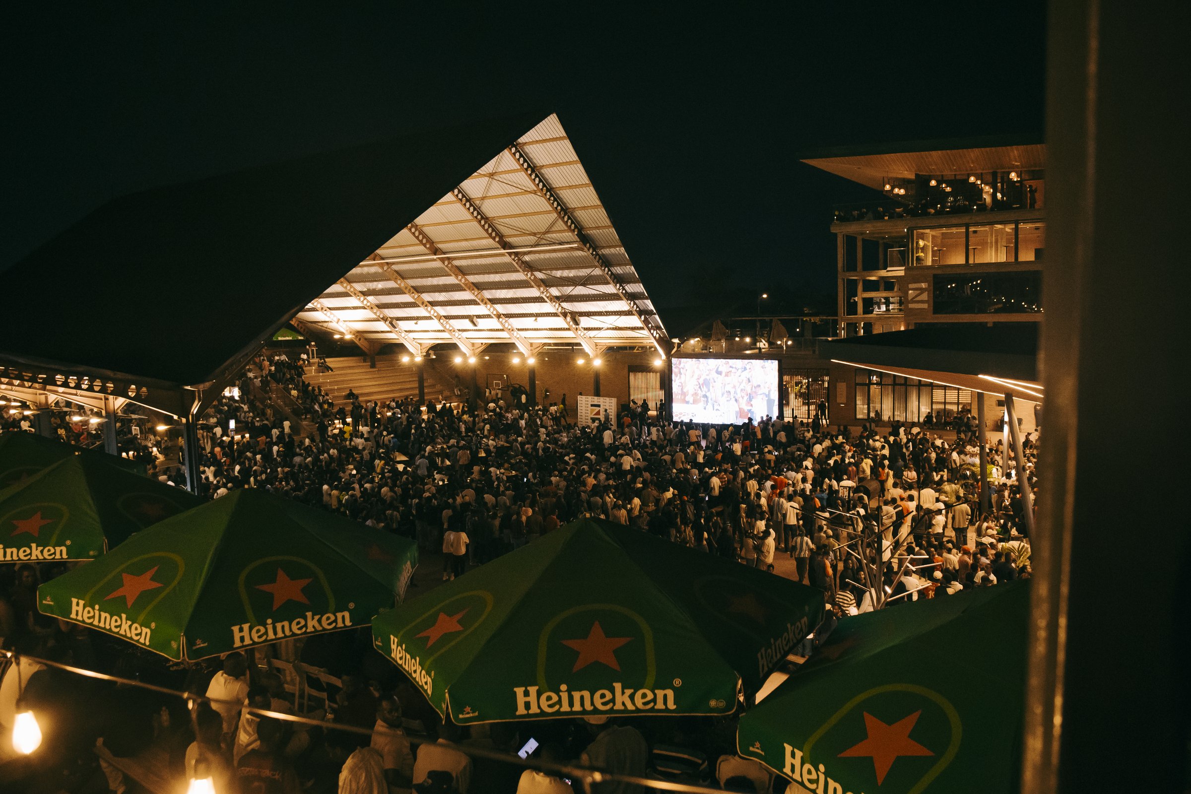 Large crowd gathered for a live outdoor screening at Zaria Court Kigali