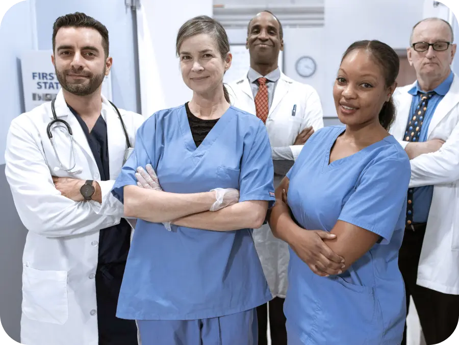 Multidisciplinary medical team posing confidently in a clinical setting