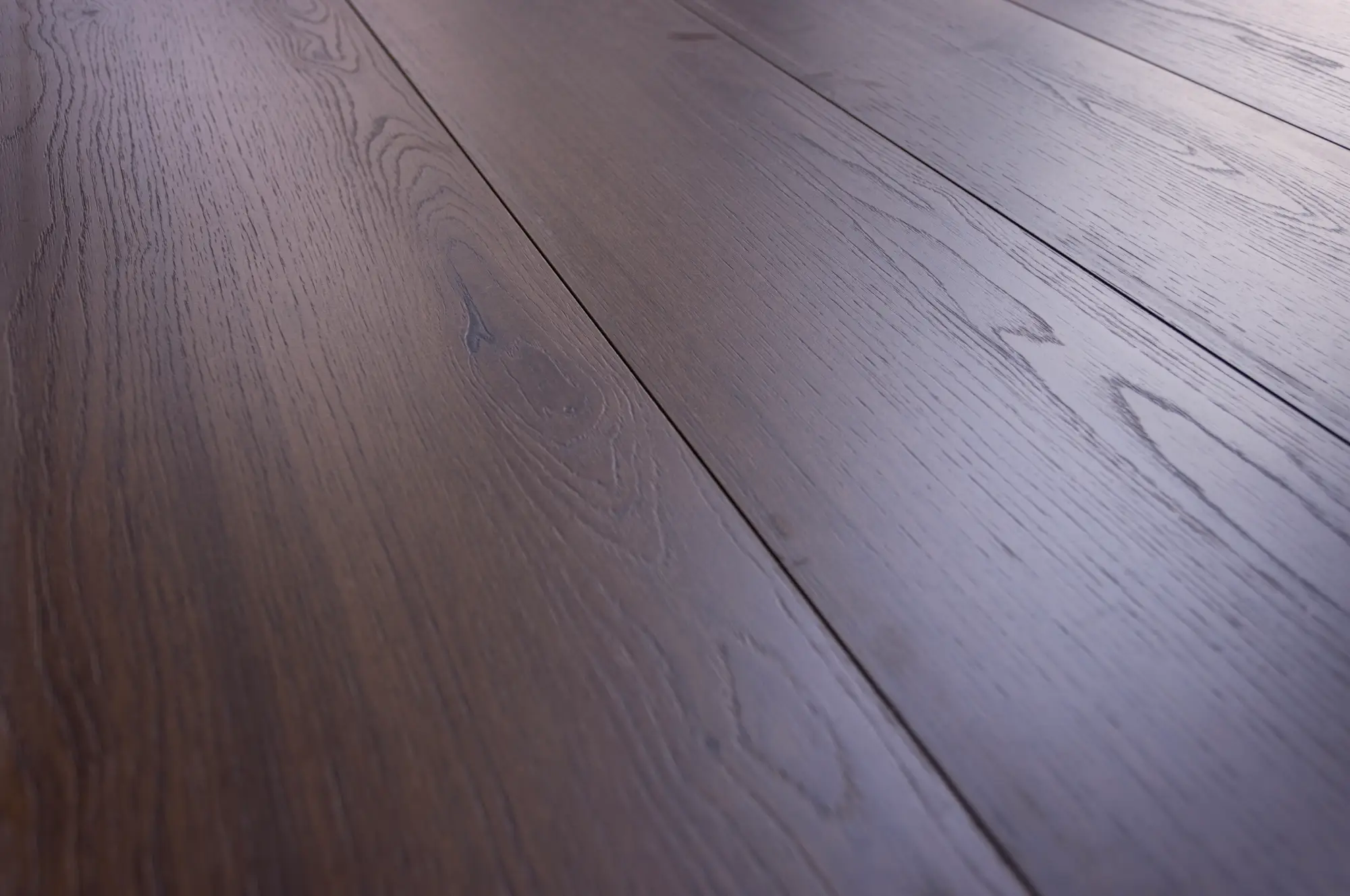 Perspective laminate flooring, code C1206, with a dark oak wood-look finish and deep grain patterns, adding elegance and sophistication to any interior.