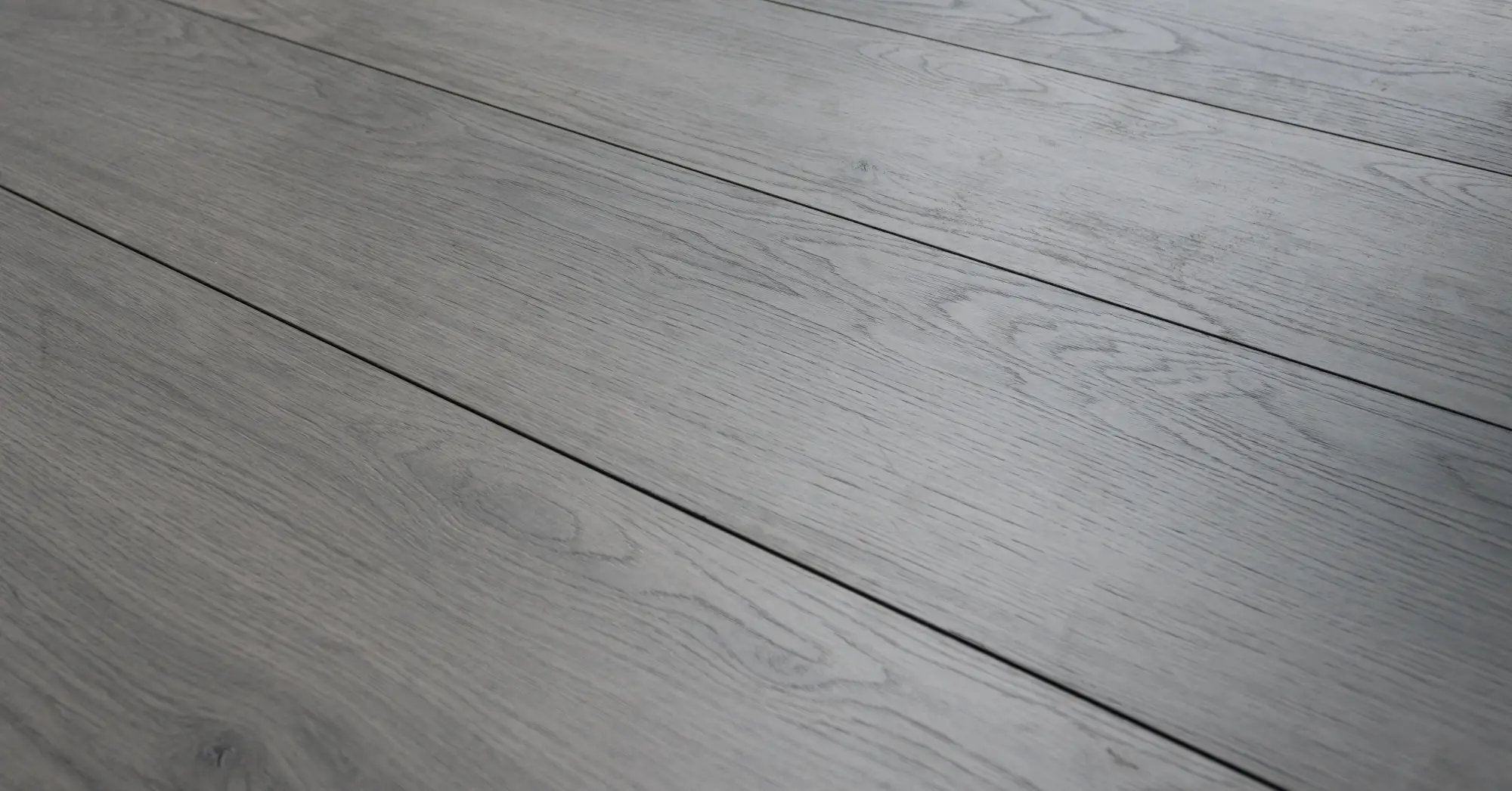 Perspective laminate flooring in gray, code C1201, featuring a modern wood-look finish that adds a sleek and contemporary style to any space.