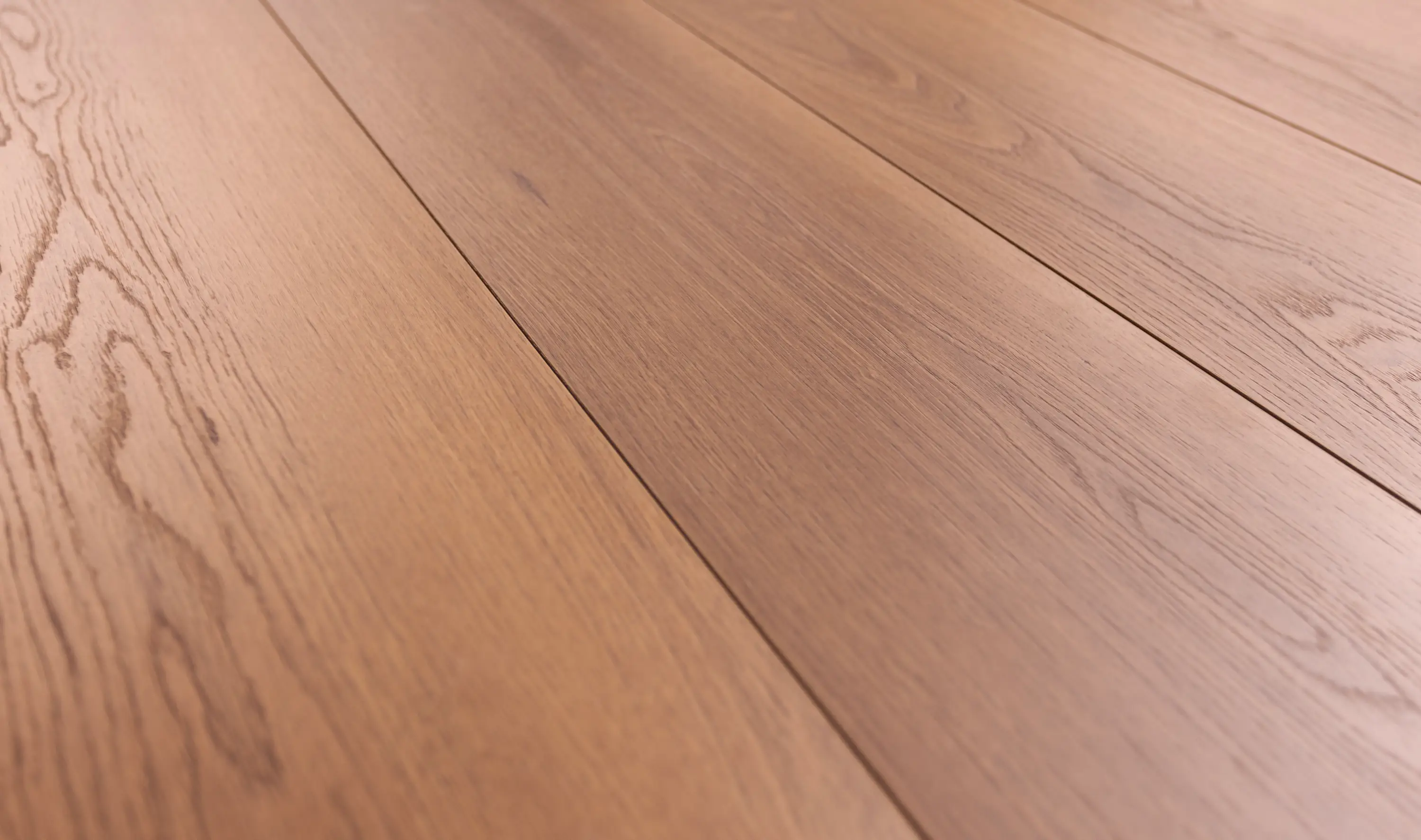 Perspective laminate flooring, code C1205, featuring a medium oak tone with natural wood grain patterns and a smooth finish for a warm, classic interior look.