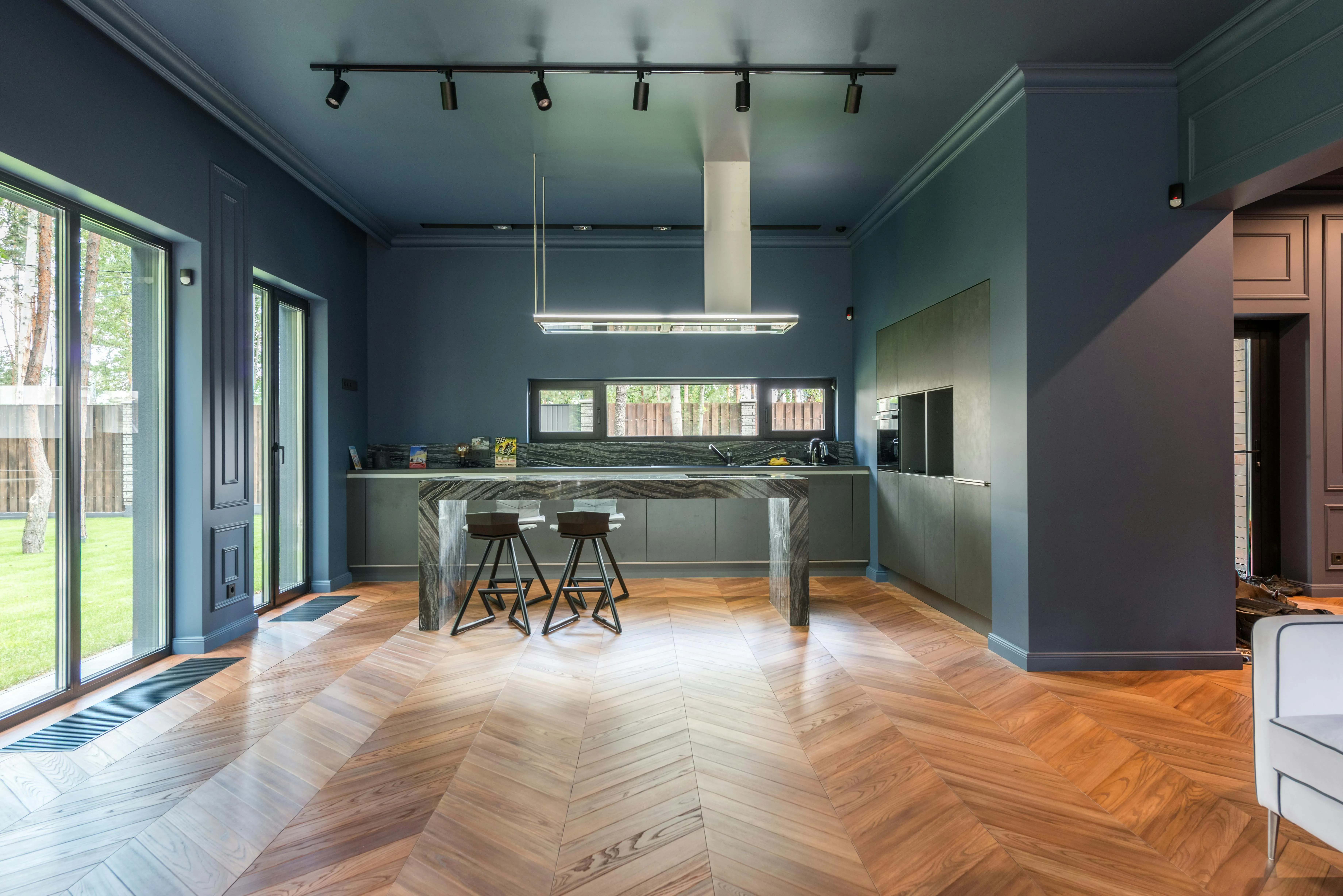 Finished herringbone hybrid flooring in a living room, in Hawaiian Brown color, adding warmth and elegance to the space.