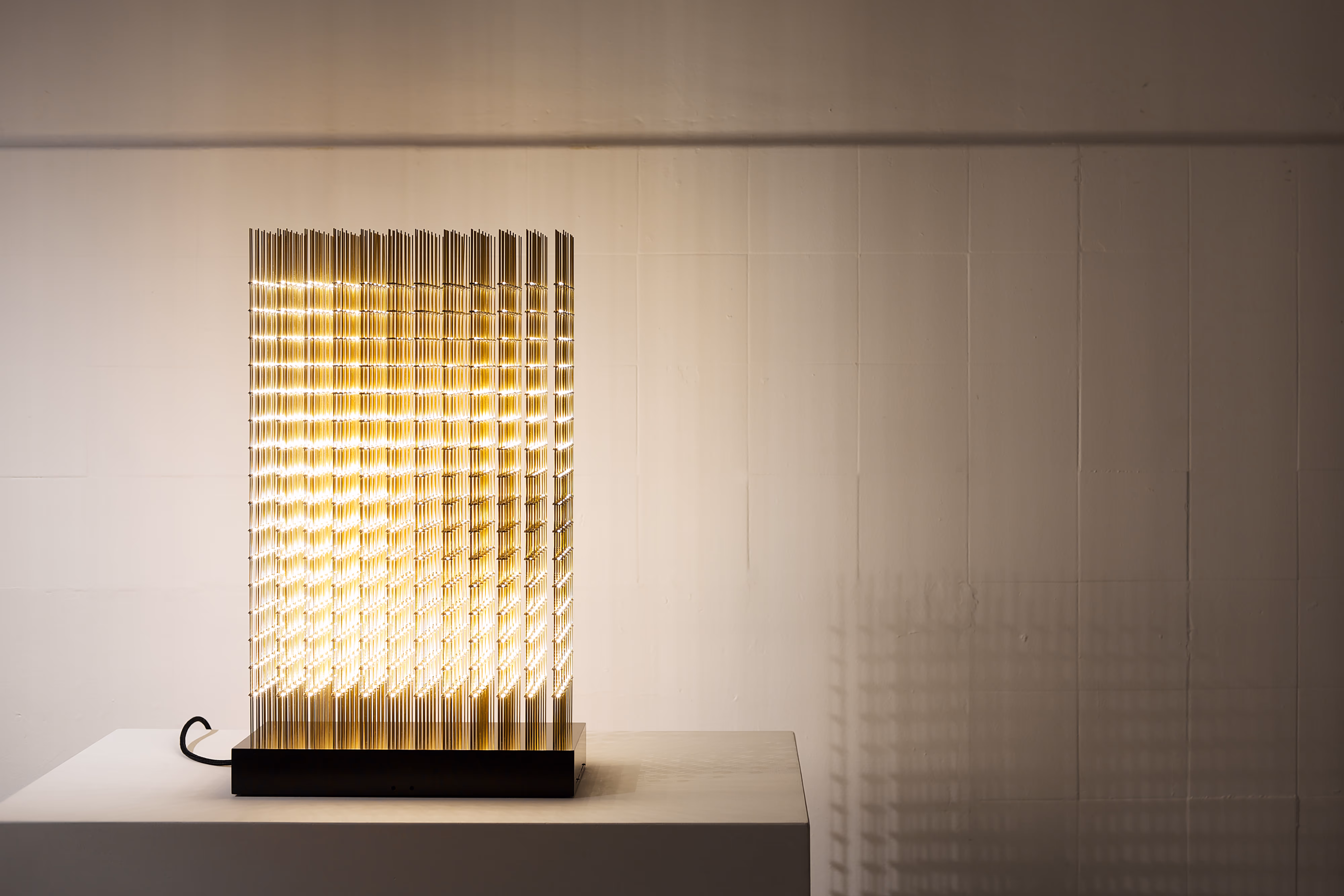 Image of a lamp made of golden lights.
Photo credit: Random International from project Swarm-Study-VI_2014
