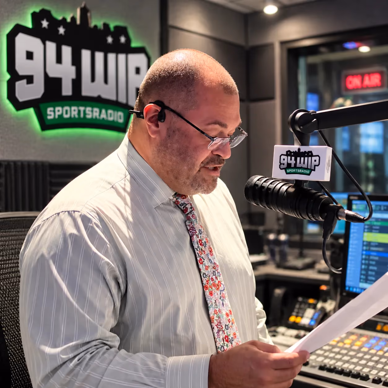 Host reading live on air in the 94 WIP Sportsradio studio