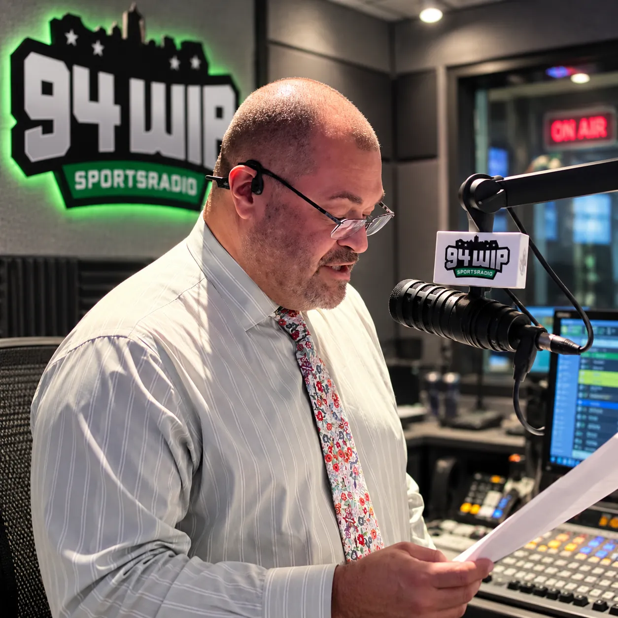 Host reading live on air in the 94 WIP Sportsradio studio