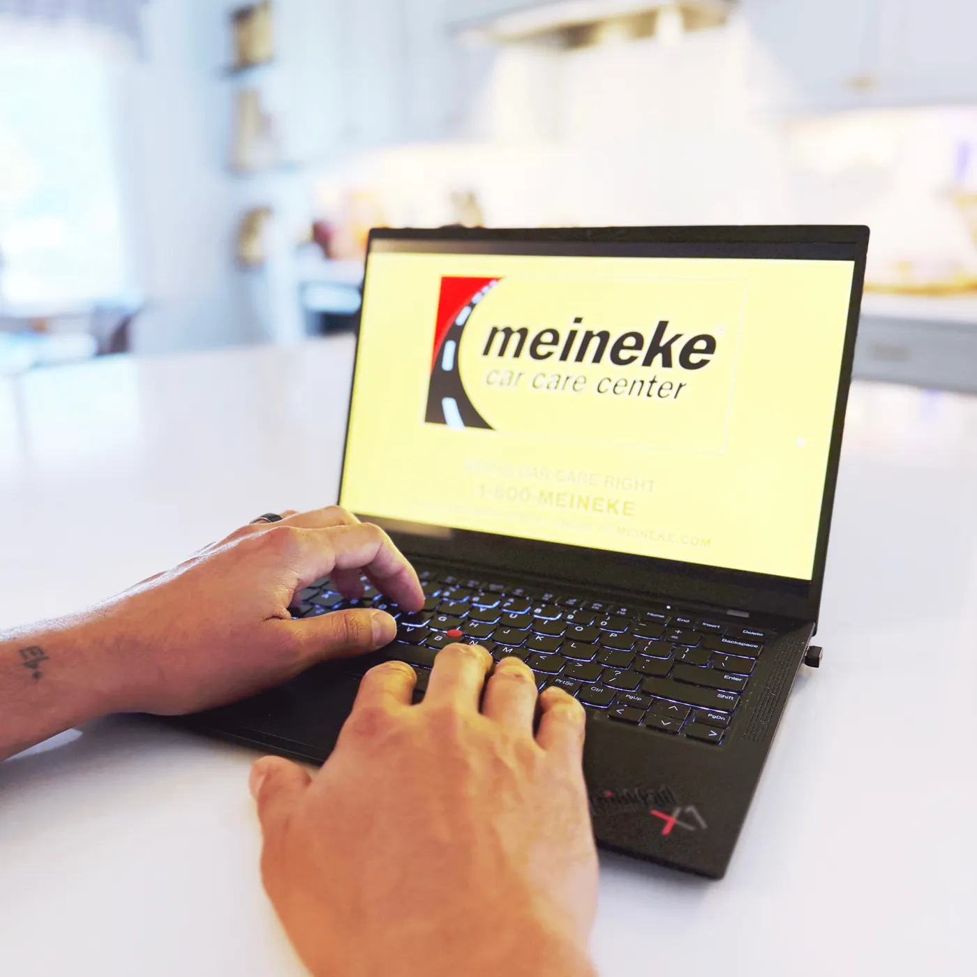 Meineke Car Care Center website on a laptop