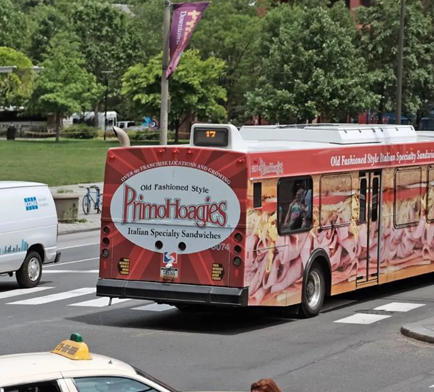 Primo Hoagies full bus wrap on a city street
