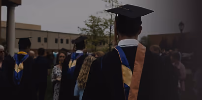 Graduate in cap and gown at a ceremony