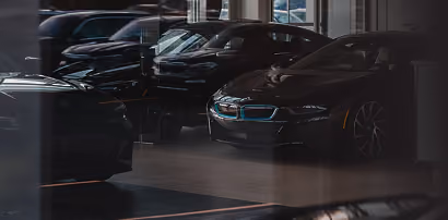 Cars parked in a dark dealership showroom