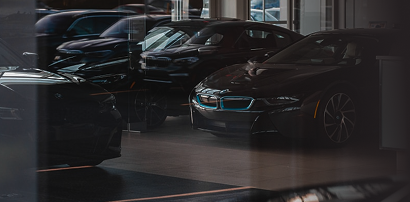 Cars parked in a dark dealership showroom