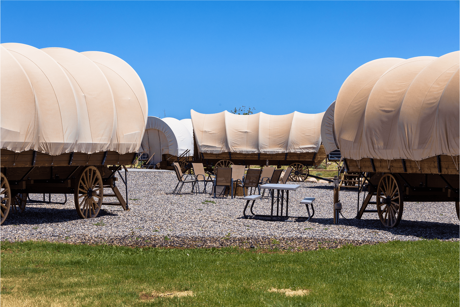 Outdoor seating area by wagon lodgings at Broken Spur Inn & Steakhouse near Capitol Reef