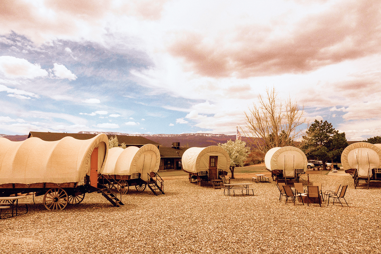 Covered wagon campground with seating at Broken Spur Inn & Steakhouse in Torrey Utah