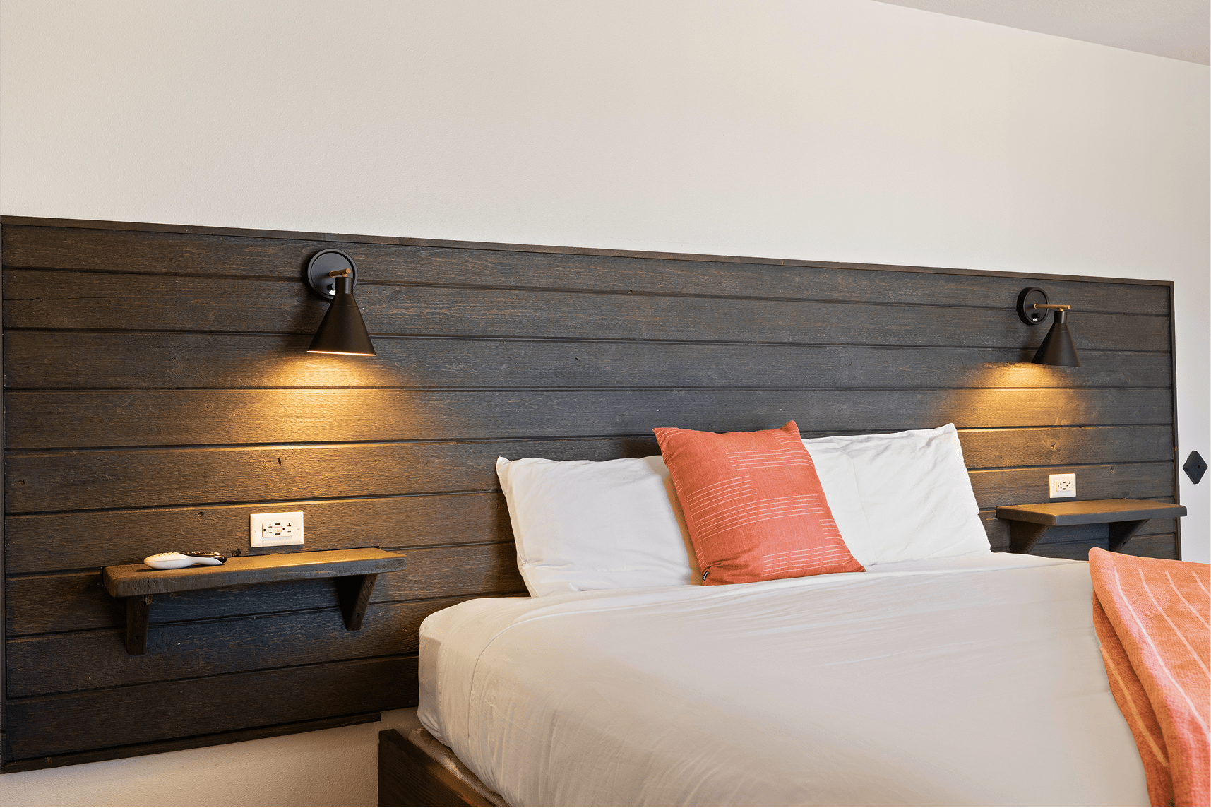 Single king bed with wood headboard at Broken Spur Inn & Steakhouse in Torrey Utah