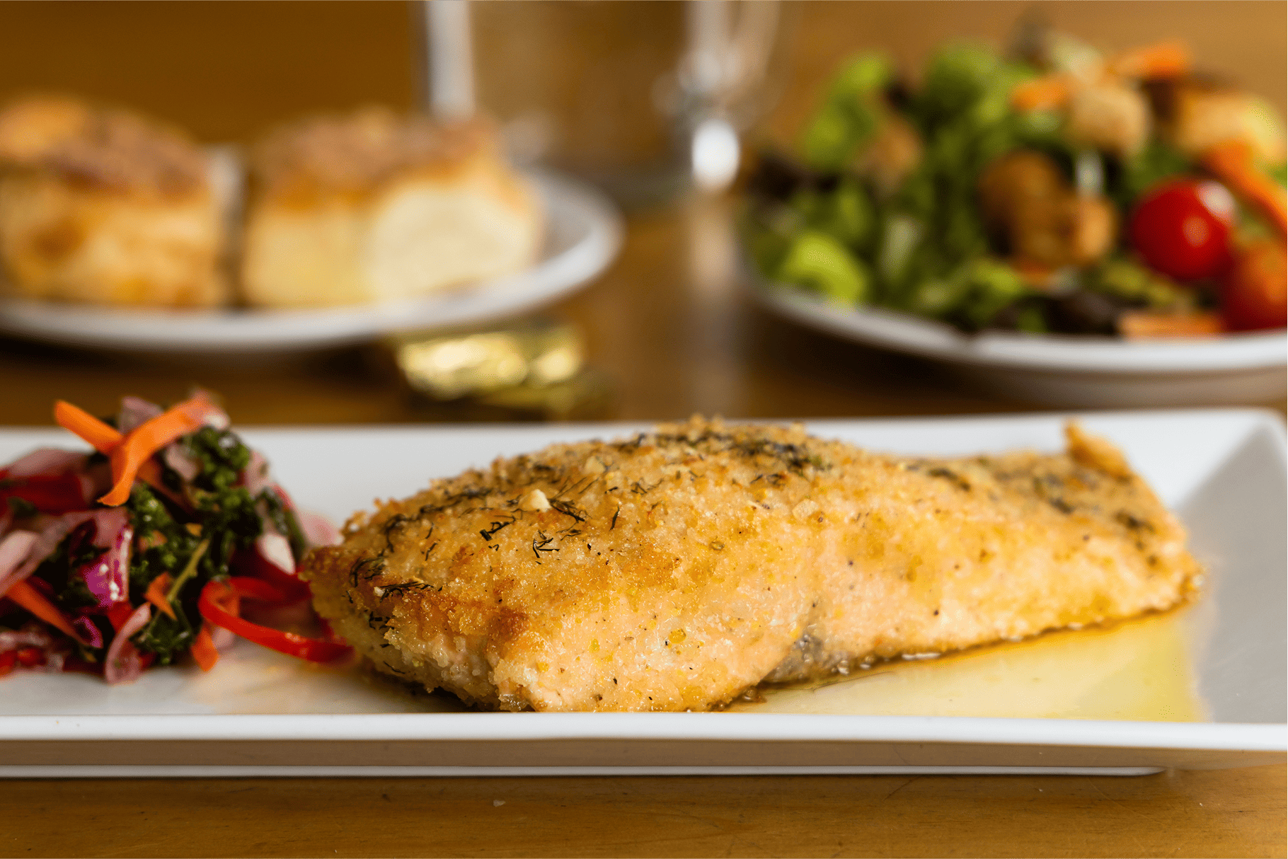 Baked salmon entrée with vegetables at Broken Spur Inn & Steakhouse