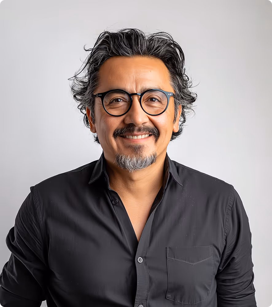 Smiling middle-aged man with black and gray hair and beard wearing round glasses and a black shirt.