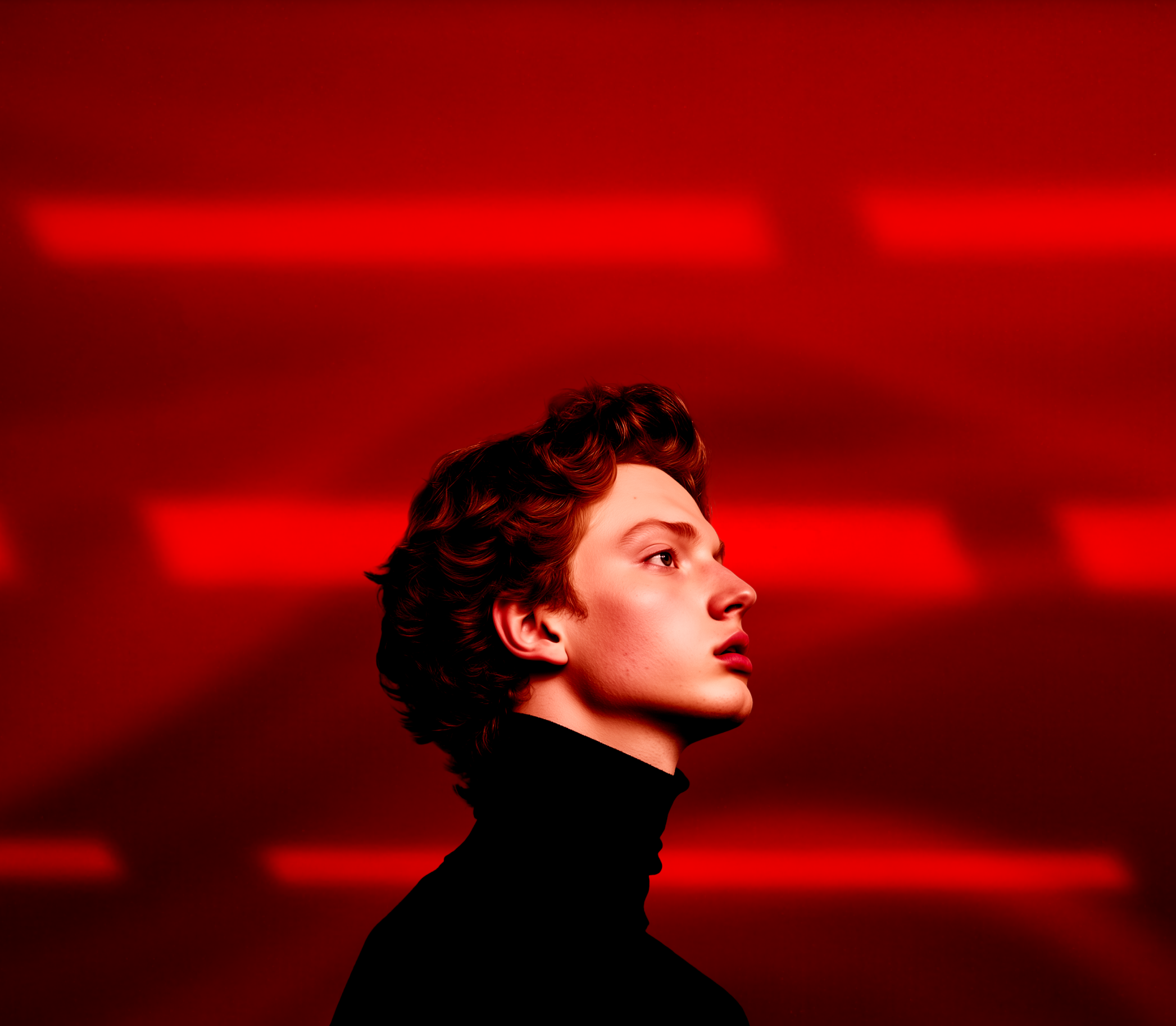 Profile of a young person with curly hair wearing a black turtleneck against a red background with horizontal light patterns.