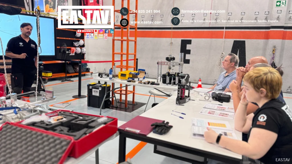 EASTAV workshop with instructor demonstrating robotics and engineering equipment to students.