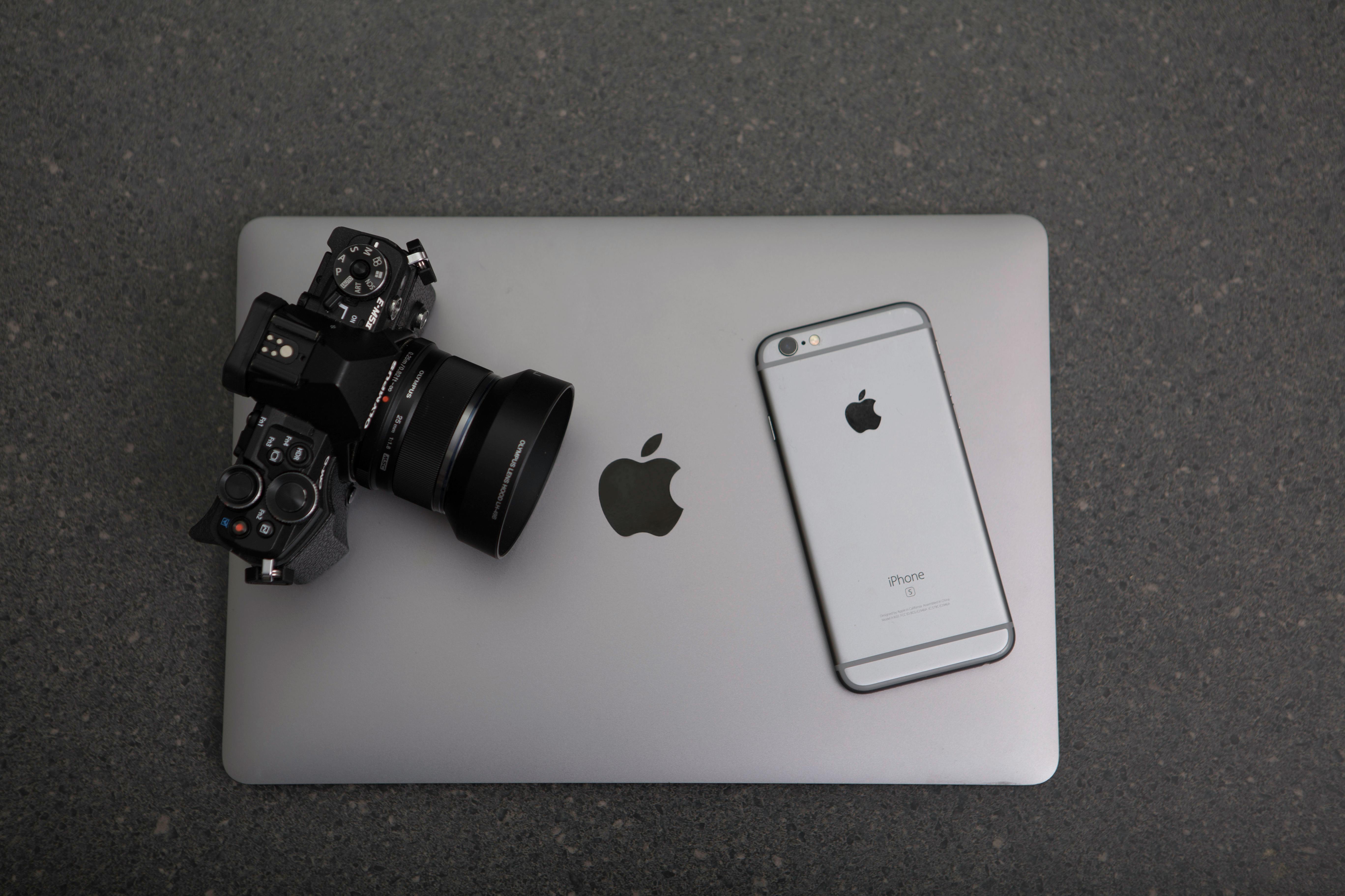 Professional camera, Macbook, and iPhone to represent usage licensing and copyright in photography and videography