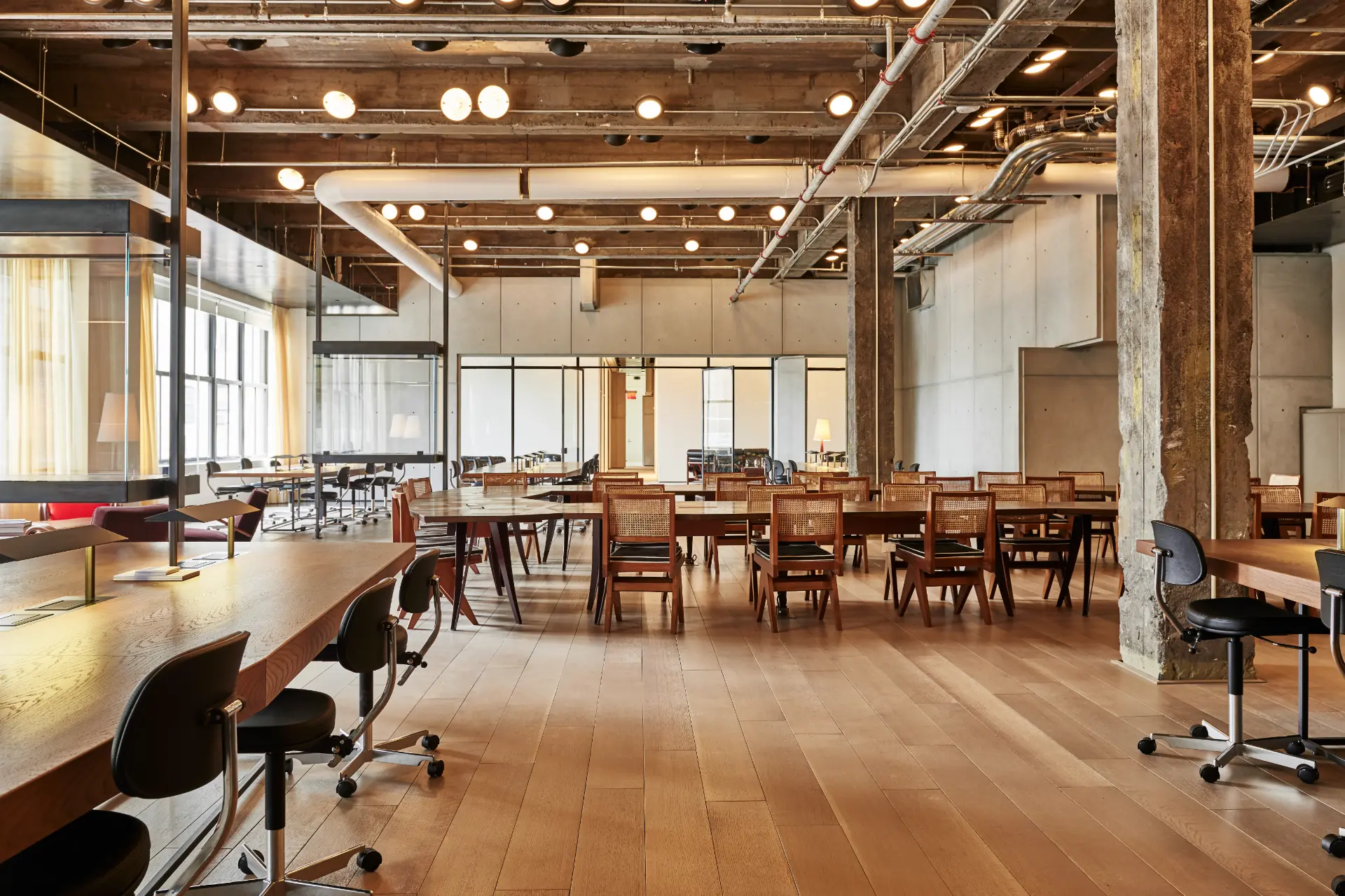 Coworking space at Spring Place with communal desks, bookshelves, and curated design.