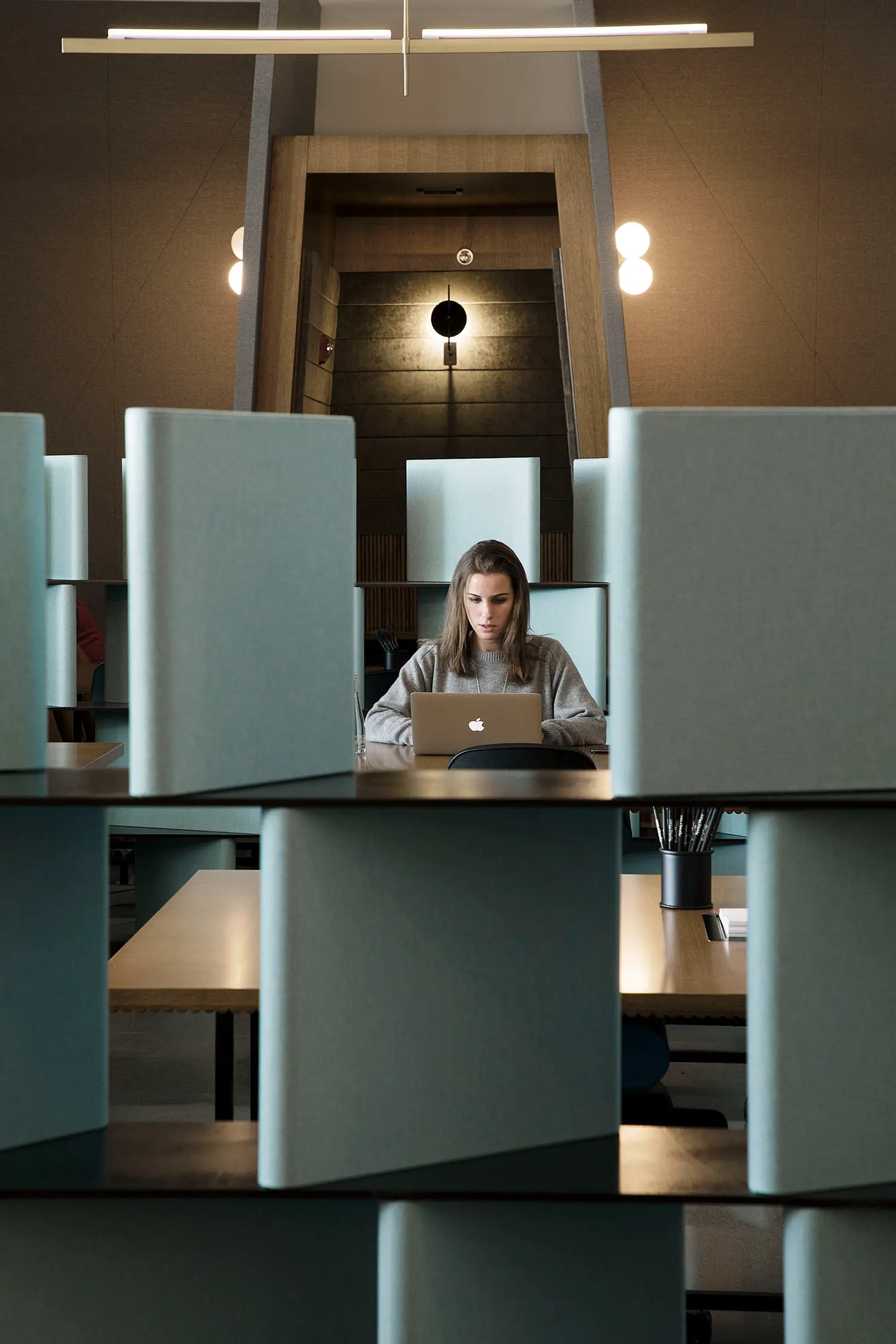 Resident desks at Spring Place with open layout and personal storage armoires