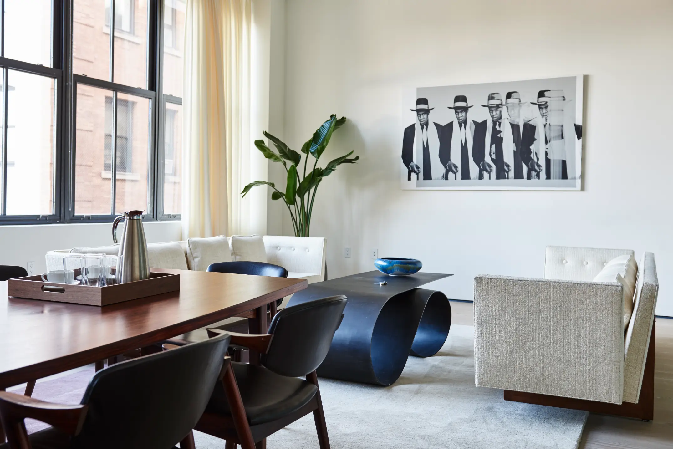 Bright, modern meeting room at Spring Place with long table, credenza, and framed poster