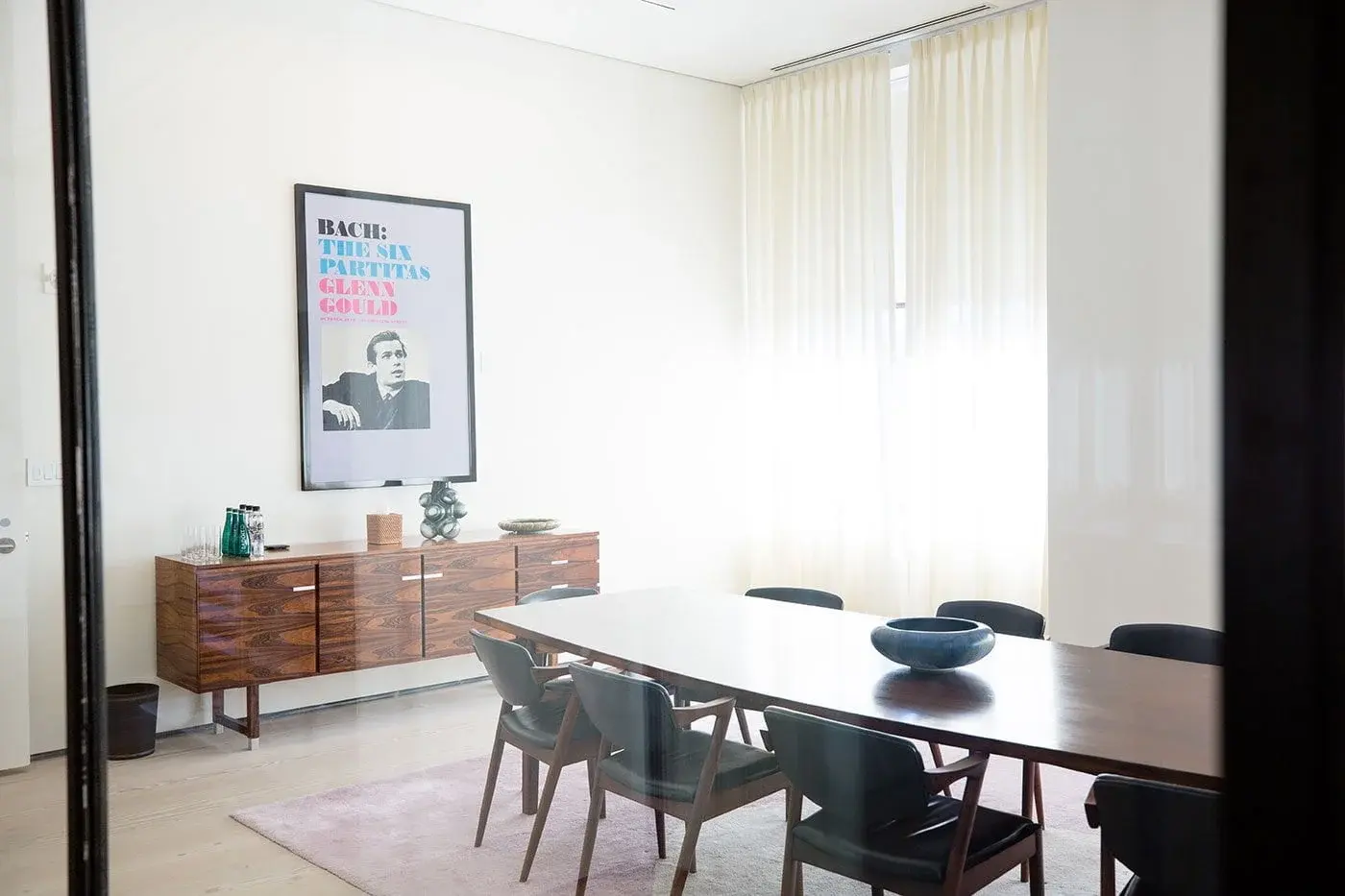 Contemporary meeting space at Spring Place featuring a table, sideboard, and wall art