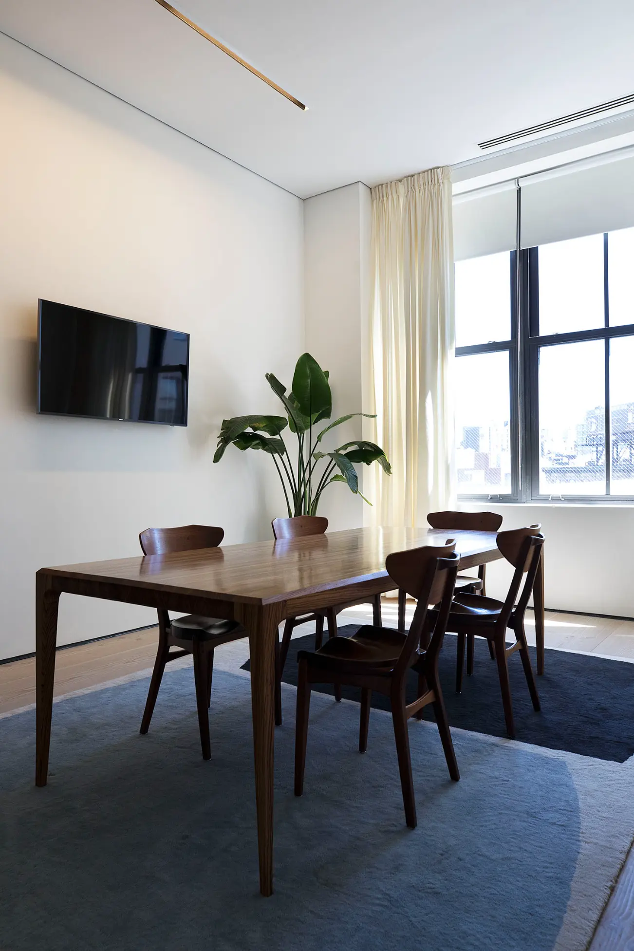 Contemporary Spring Place meeting space with long table and windowed balcony view