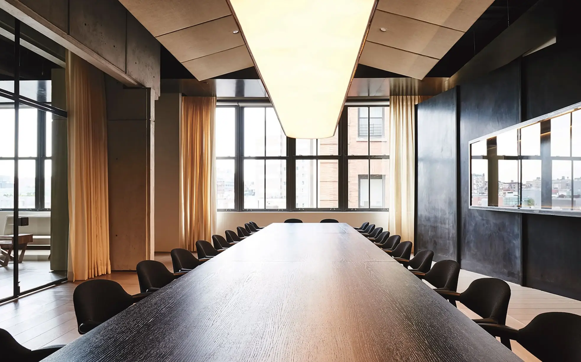 Contemporary meeting space at Spring Place featuring a long table and relaxed lounge zone