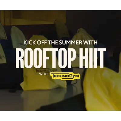 Text reading “Kick off the summer with ROOFTOP HIIT with Technogym” displayed over a dimly lit background featuring yellow workout equipment, suggesting a rooftop fitness event.