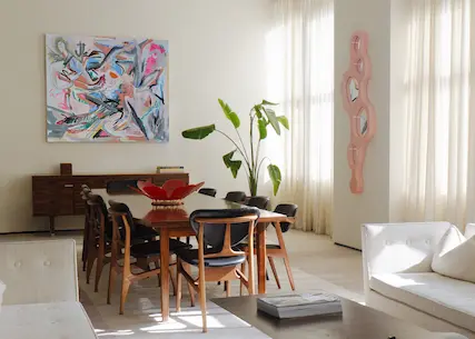Art table with framed artwork, announcing Tuleste Factory as official gallery partner at Spring Place