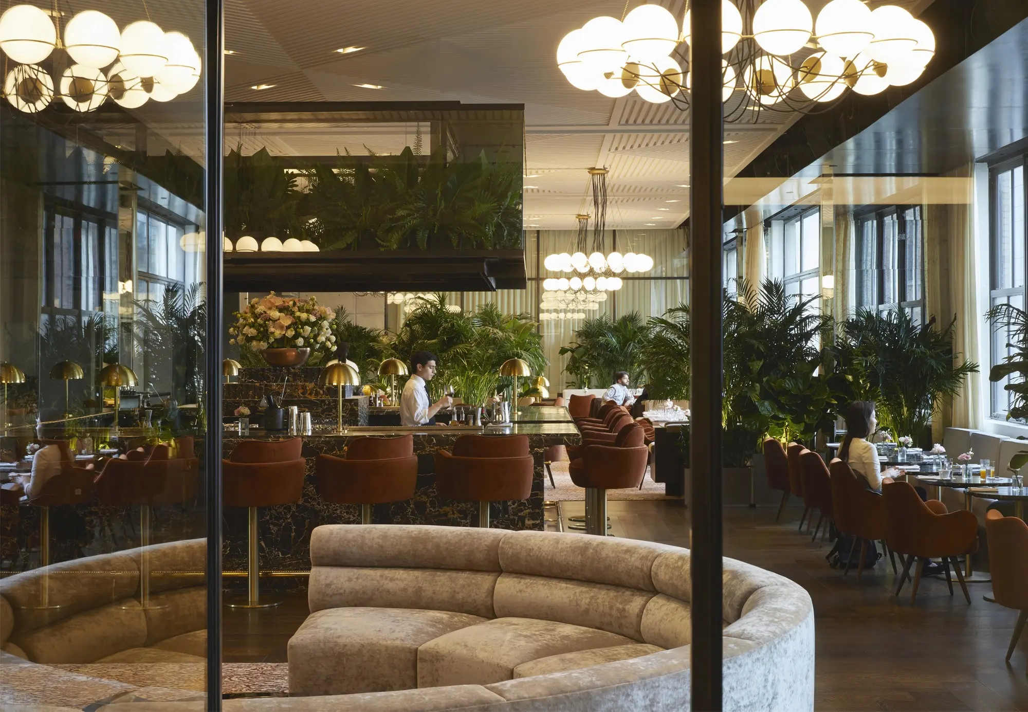 Wide angle view of lounge space at Spring Place with a view of the bar in the back