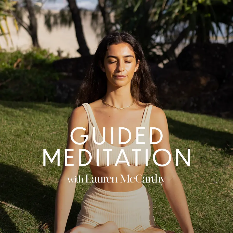 'guided meditation' white text against backdrop with woman in meditation, yoga pose