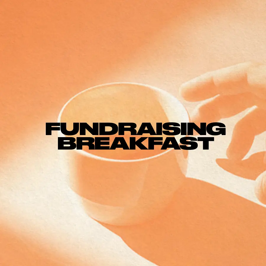 "Fundraising Breakfast" in all caps, bold letters, against orange background of a hand reaching out for a cup