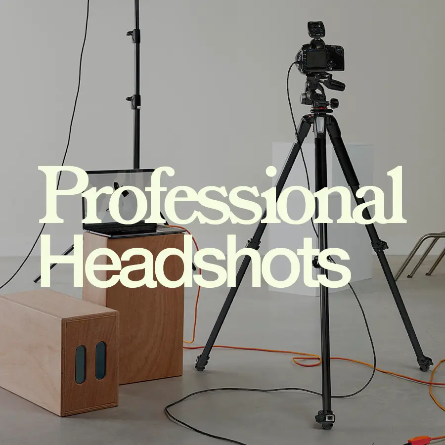 "Professional Headshots written in creamy white against a background of a photo studio with camera equipment set up