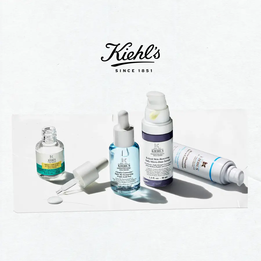 Skincar serums lined up next to each other against an off white background, with a black tape that has text 'shop treatments'