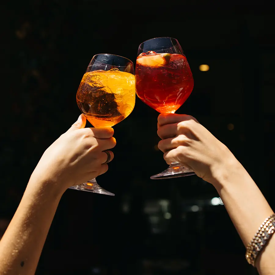 aperol spritz glasses cheering.