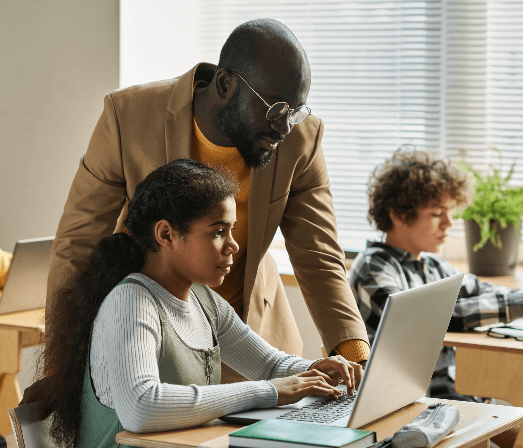 Student and teacher using a computer 