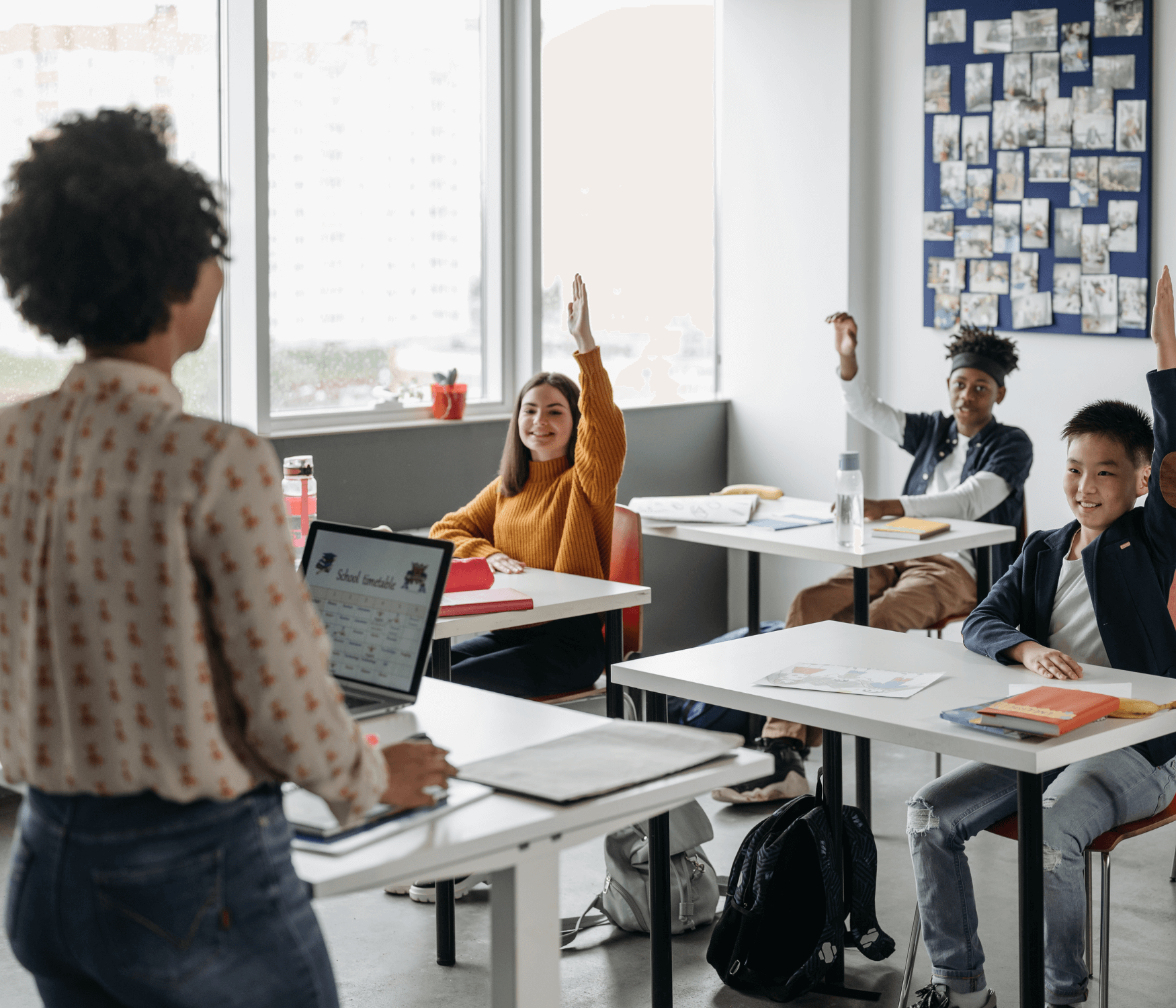 Students and teacher at school using a computer