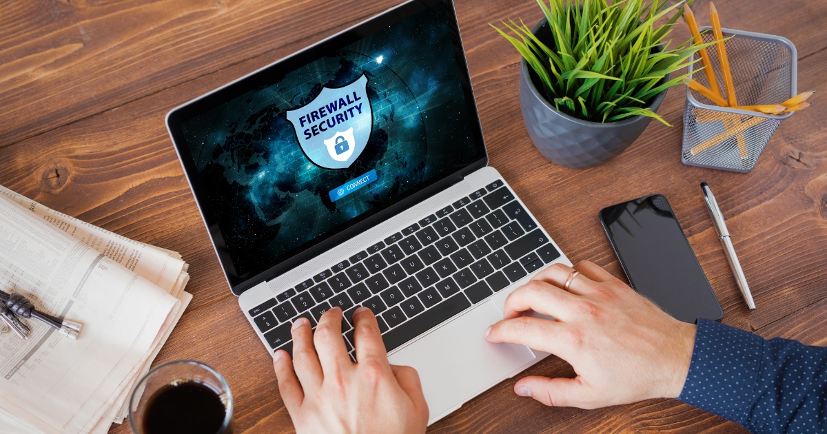 Person working on a laptop with NGFW and WAF security considerations in focus.