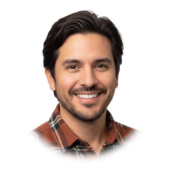 Smiling man with dark hair and a beard wearing a brown plaid shirt.