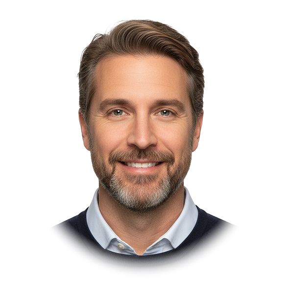 Portrait of a smiling middle-aged man with light brown hair and beard, wearing a white shirt and dark sweater.