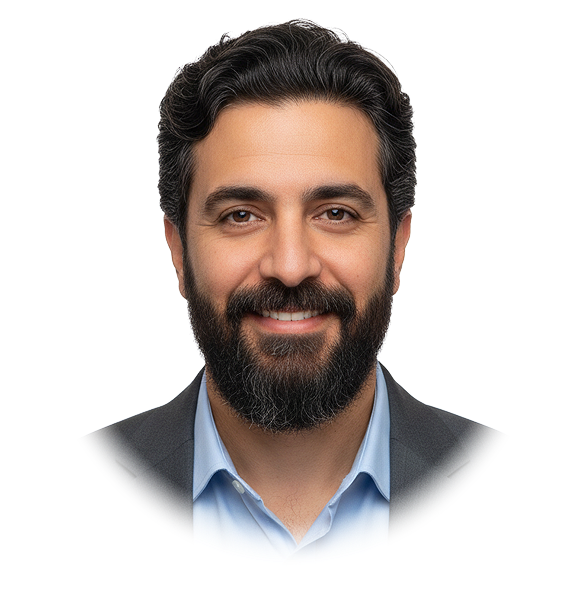 Smiling man with dark hair, beard, and mustache wearing a light blue shirt and dark blazer.