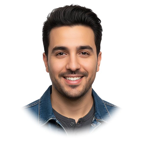 Smiling man with neatly styled dark hair wearing a denim jacket and dark shirt.