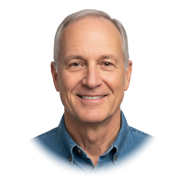 Smiling older man with gray hair wearing a blue denim shirt on a transparent background.