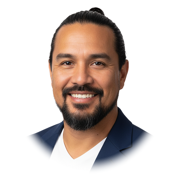 Smiling man with dark hair tied back, a beard, wearing a navy blazer and white shirt.