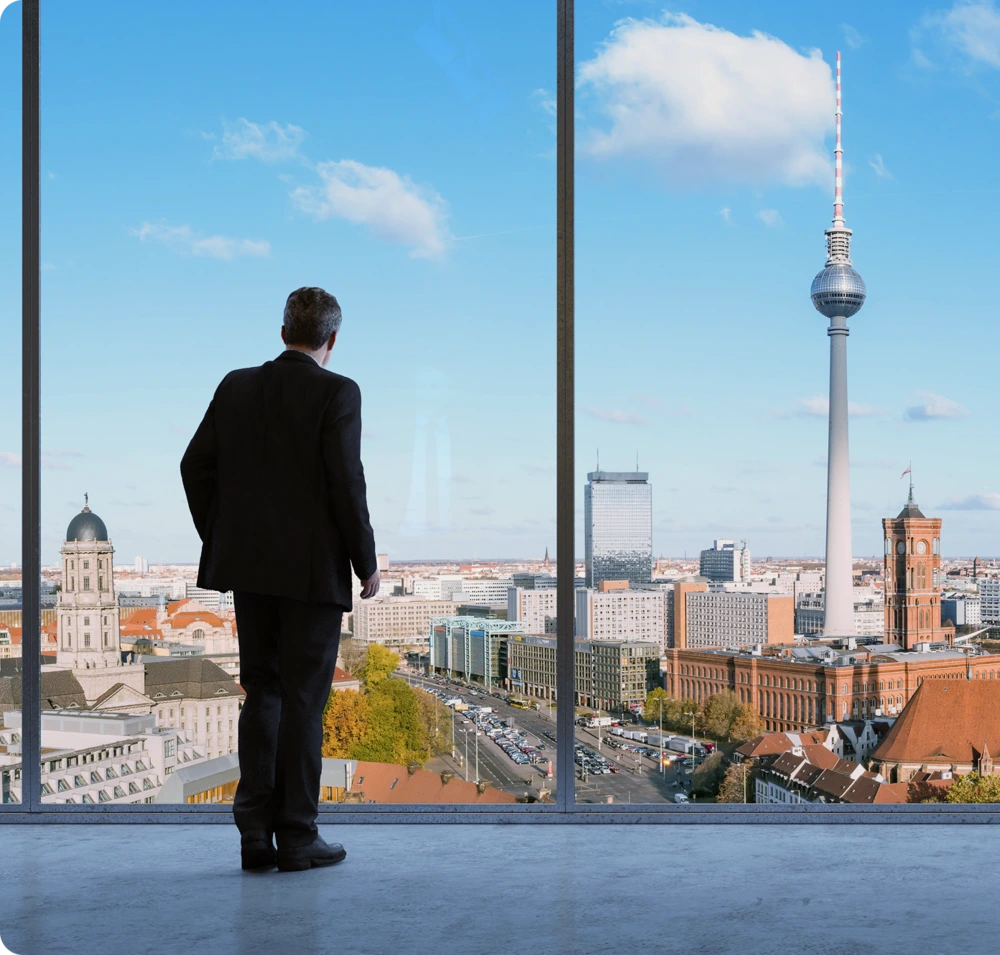 Man looking over skyline from office window