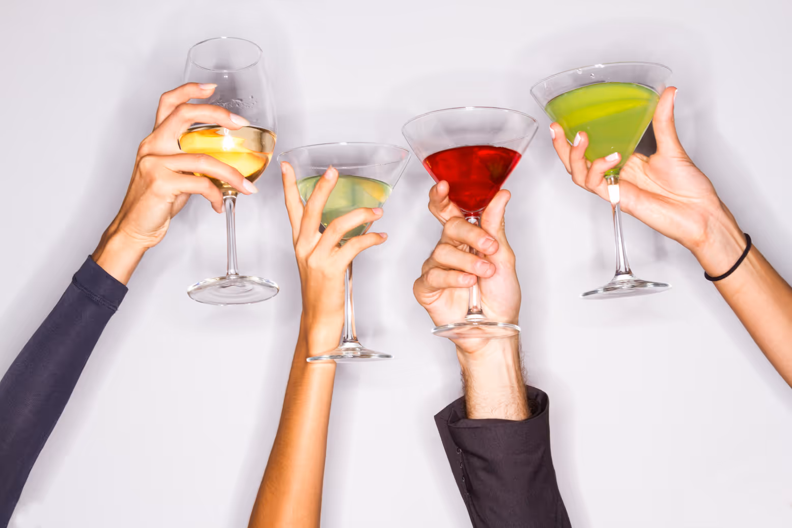 Group of people toasting with Madame Mocktail zero-proof drinks at a celebration